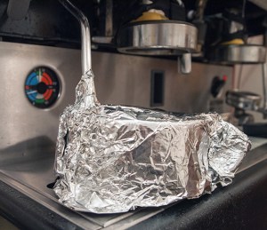 When everything is aligned, I cover the mug and steam wand tip with tinfoil plus several towels to keep the steam in.